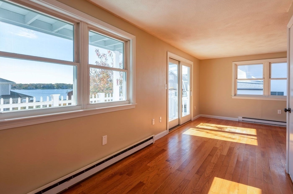 62 Eastern Point Road, Unit 3 Gloucester, MA 01930 - Photo 10 of 27 a view of an empty room with wooden floor and a window