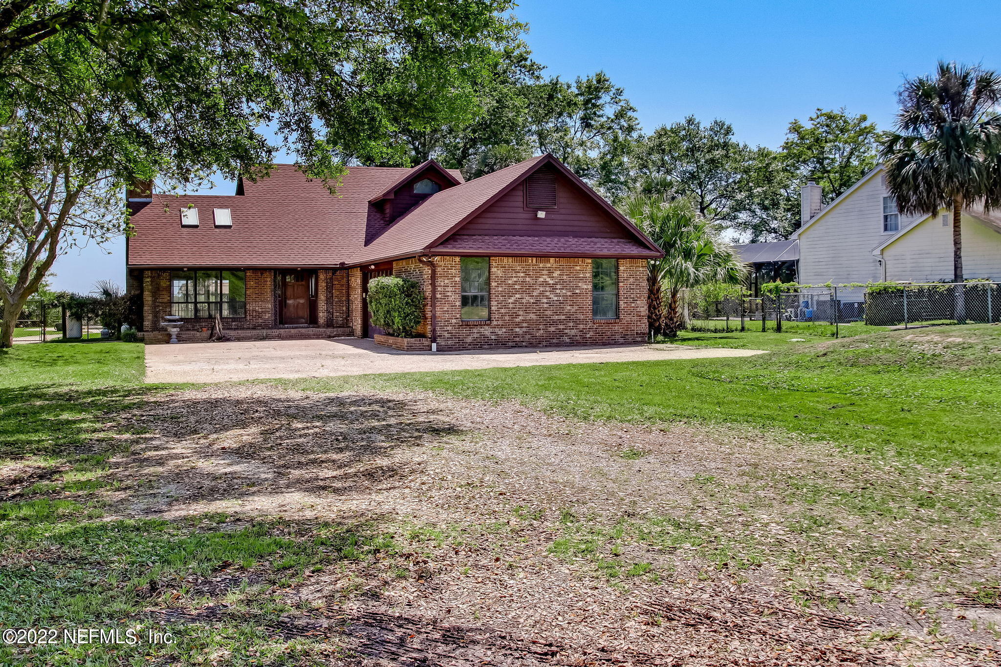75055 Edwards Road Yulee, FL 32097 - Photo 1 of 34 a front view of a house with a yard and garage