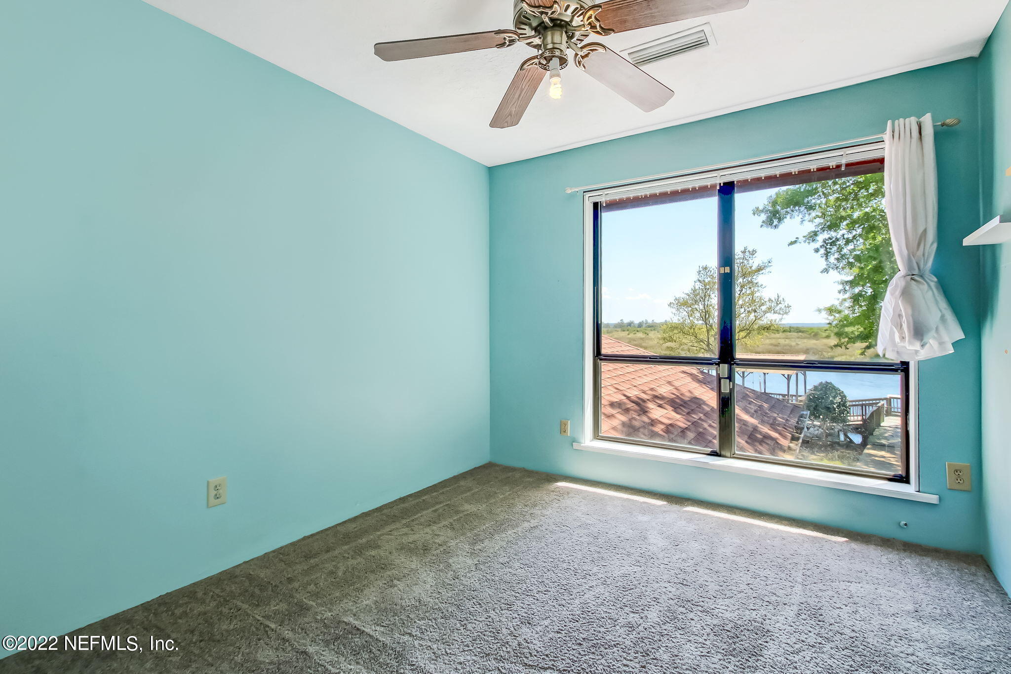 75055 Edwards Road Yulee, FL 32097 - Photo 17 of 34 an empty room with window and ceiling fan