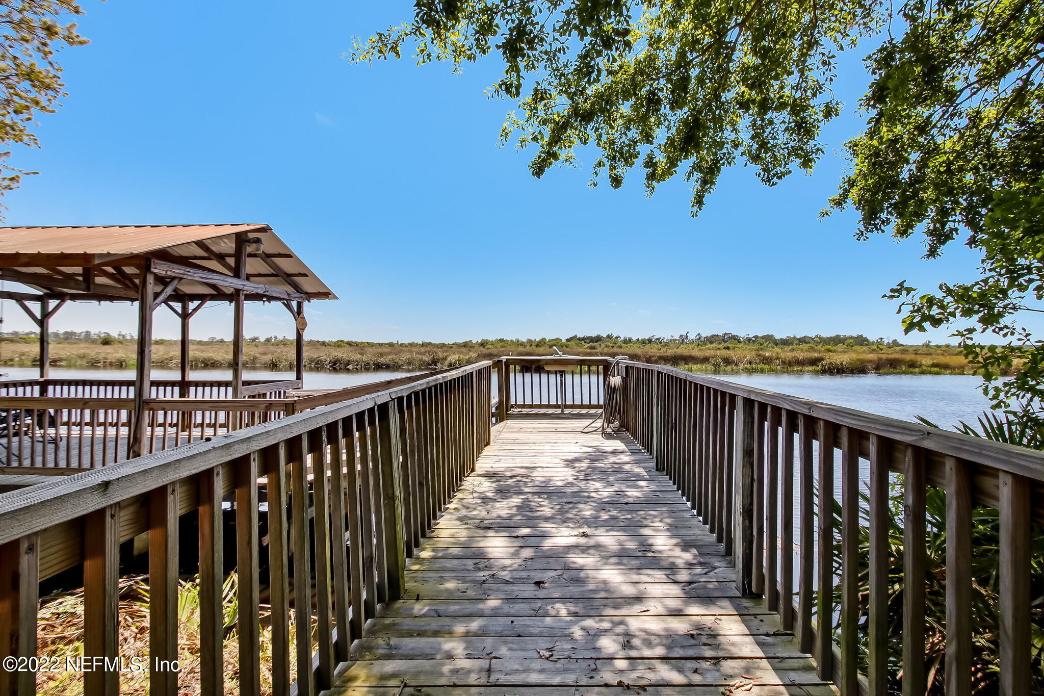 75055 Edwards Road Yulee, FL 32097 - Photo 28 of 34 a view of a balcony with wooden floor and fence