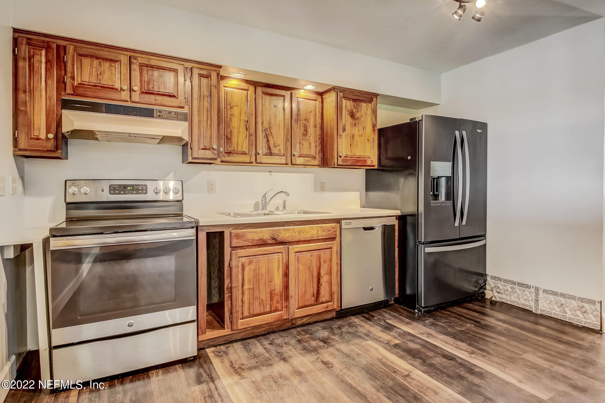 75055 Edwards Road Yulee, FL 32097 - Photo 6 of 34 a kitchen with stainless steel appliances granite countertop a stove a sink and a refrigerator