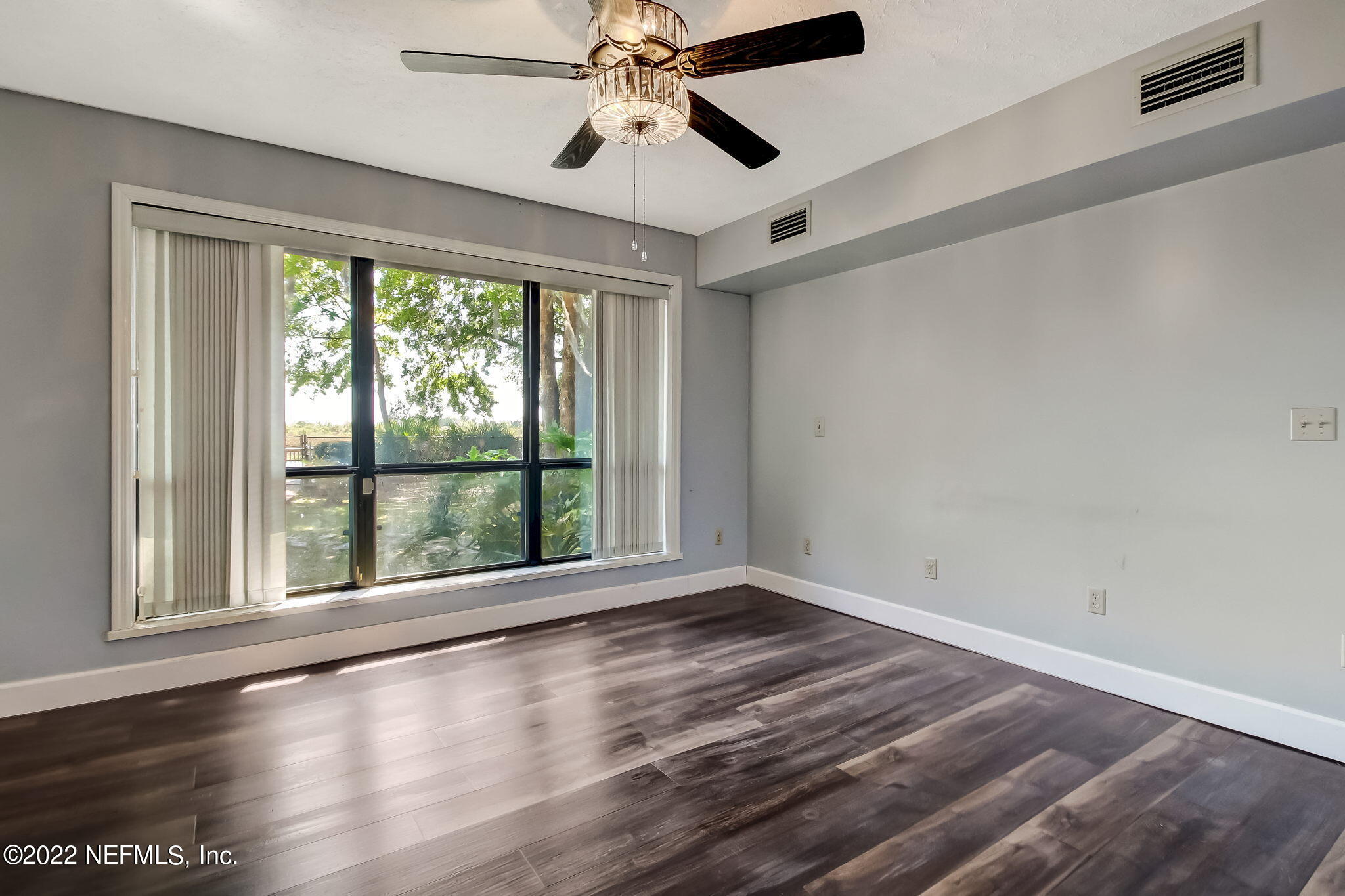 75055 Edwards Road Yulee, FL 32097 - Photo 10 of 34 a view of an empty room with wooden floor and a window