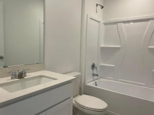 a bathroom with a sink toilet and a bathtub
