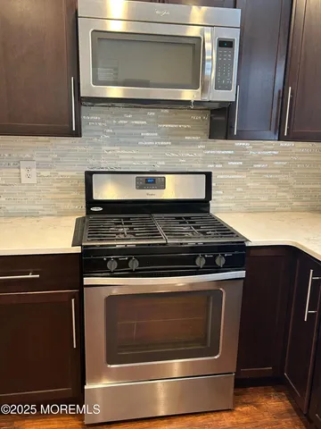 a stove top oven sitting inside of a kitchen