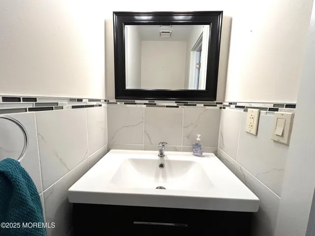 a bathroom with a sink vanity and mirror