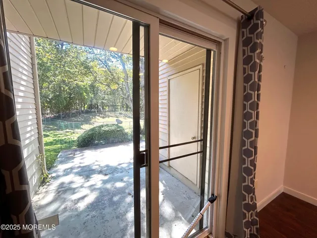 a view of a glass door with wooden floor