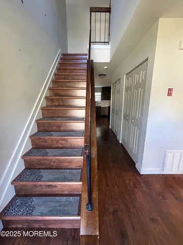 a view of entryway and hall with wooden floor