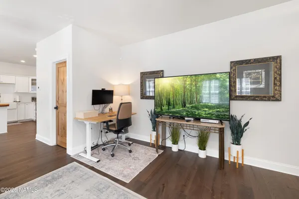 a workspace with furniture and a flat screen tv