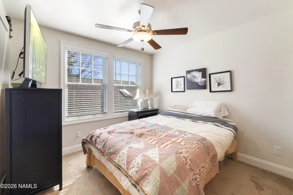a bedroom with a large bed and a window