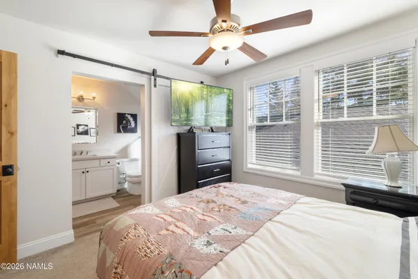 a bedroom with a large bed and a window