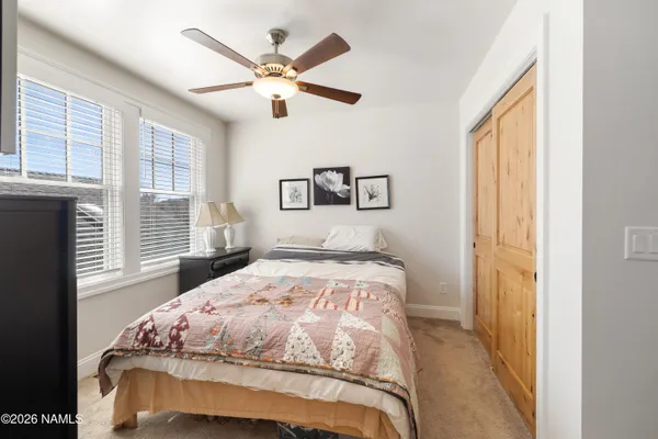 a bedroom with a large bed and a window