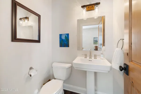 a bathroom with a toilet a sink and mirror