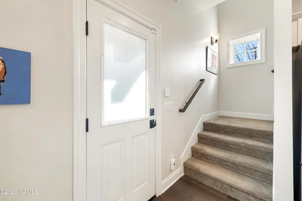 a view of staircase with wooden floor and fan