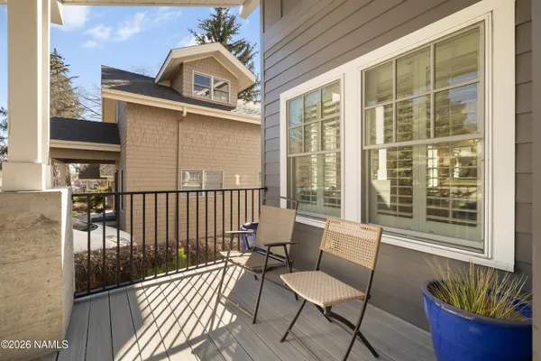 a view of a balcony with chair and the potted plant