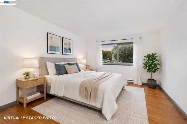 a bedroom with bed and a potted plant