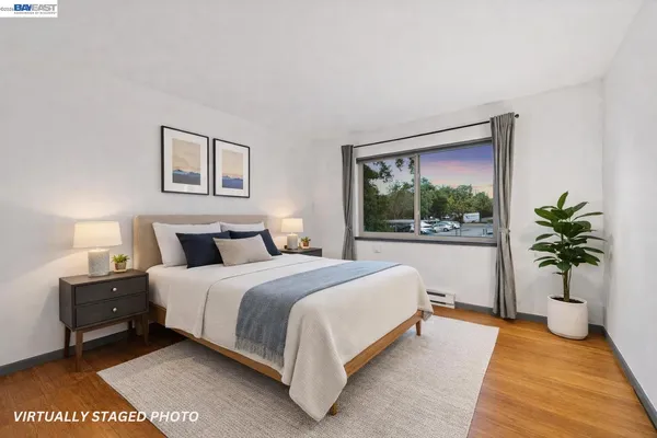 a bedroom with a large bed and a potted plant