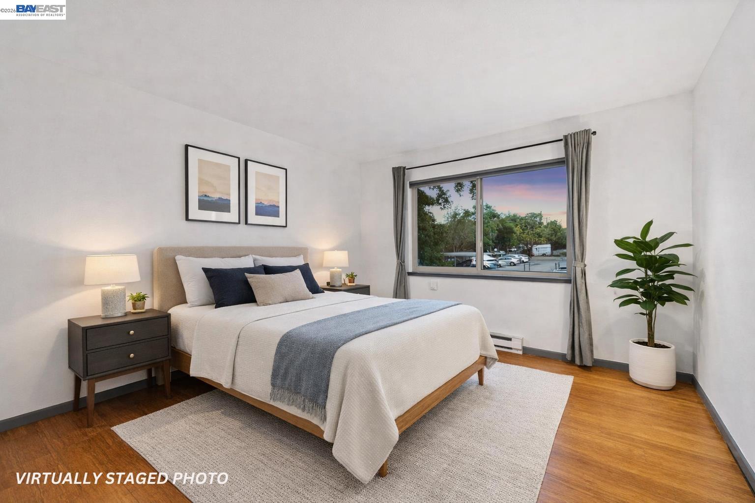 1321 Webster Street, Unit D116 Alameda, CA 94501 - Photo 7 of 22 a bedroom with a large bed and a potted plant