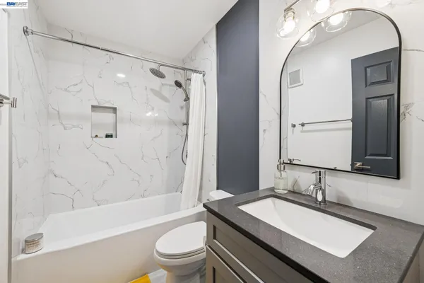 a bathroom with a sink double vanity mirror and a bathtub