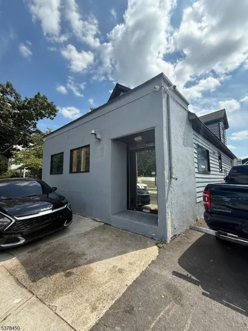 a backyard of a house with barbeque oven and barbeque oven