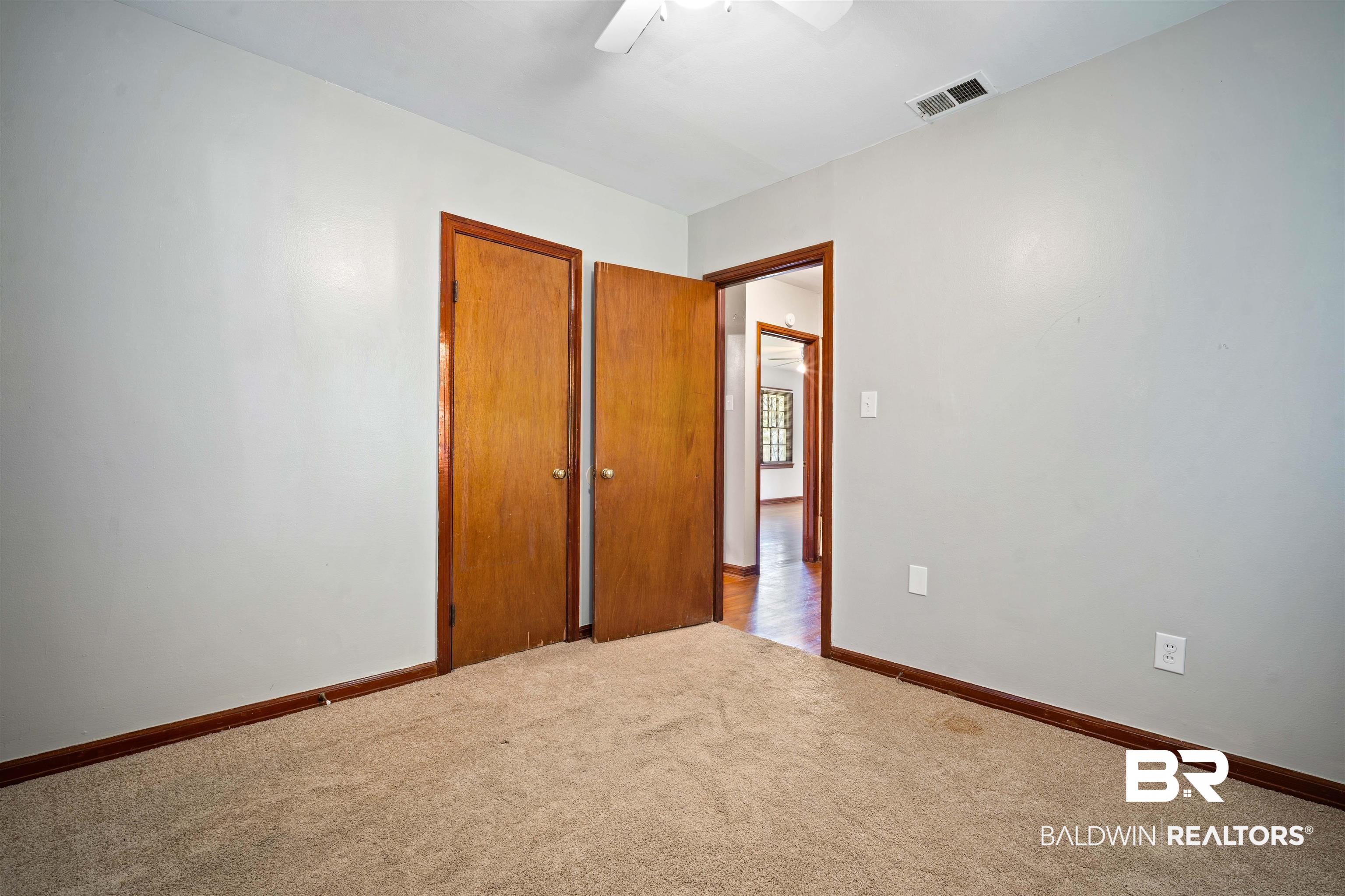 9 Elizabeth Avenue Mobile, AL 36611 - Photo 15 of 19 Carpeted empty room with a ceiling fan and baseboards