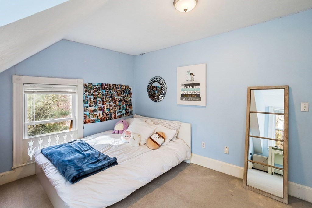 20 Gowell Lane Weston, MA 02493 - Photo 20 of 32 a bed sitting in a bedroom next to a window