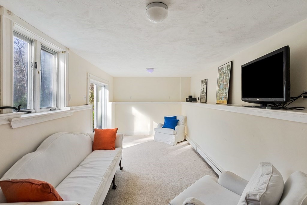 20 Gowell Lane Weston, MA 02493 - Photo 24 of 32 a living room with furniture and a flat screen tv