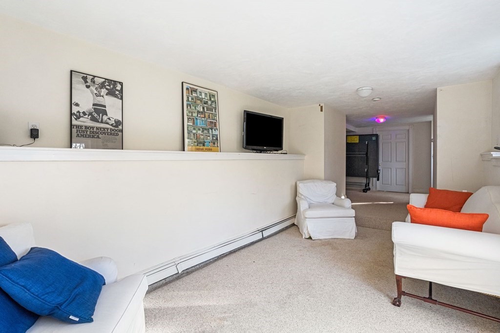 20 Gowell Lane Weston, MA 02493 - Photo 25 of 32 a living room with furniture and a flat screen tv