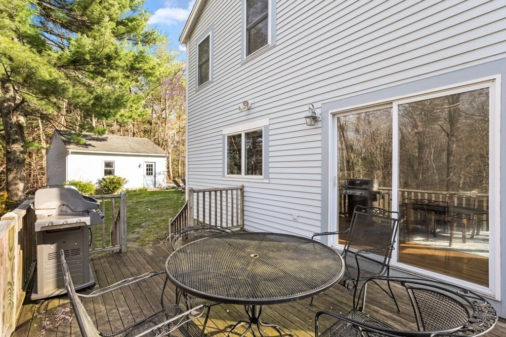 20 Gowell Lane Weston, MA 02493 - Photo 29 of 32 a backyard of a house with table and chairs