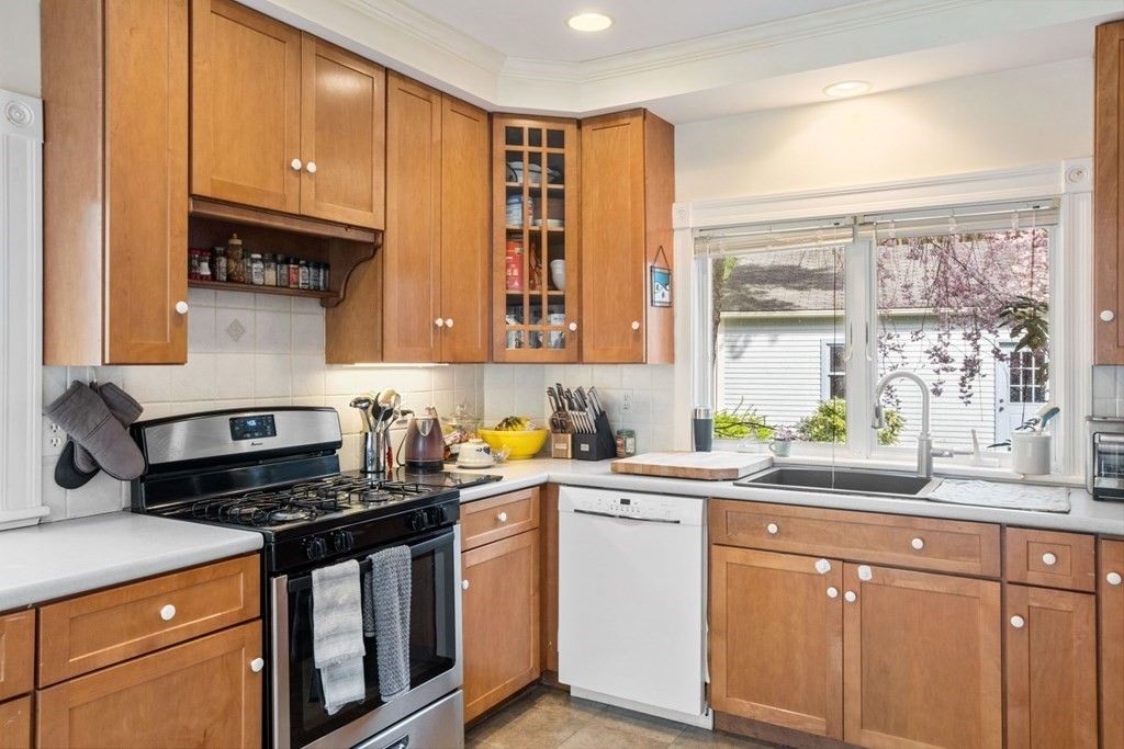 20 Gowell Lane Weston, MA 02493 - Photo 6 of 32 a kitchen with stainless steel appliances a sink stove and cabinets