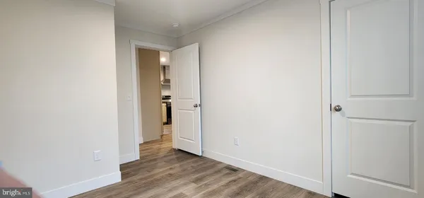 a view of an empty room with wooden floor