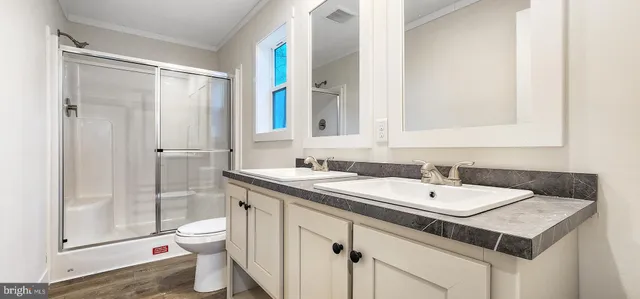 a bathroom with a sink and a mirror with toilet