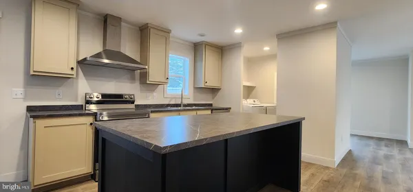 a kitchen with a sink a stove and cabinets