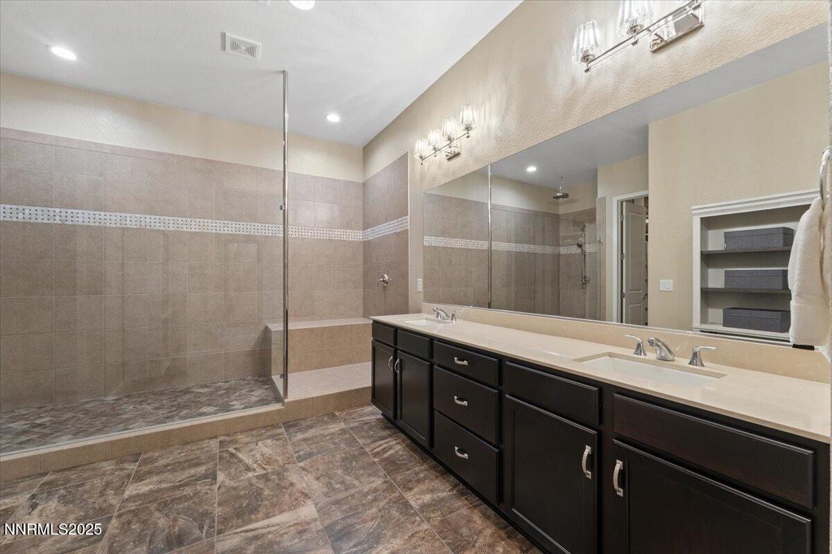 9822 Dyevera Lane Reno, NV 89521 - Photo 25 of 44 a bathroom with a double vanity sink mirror and shower