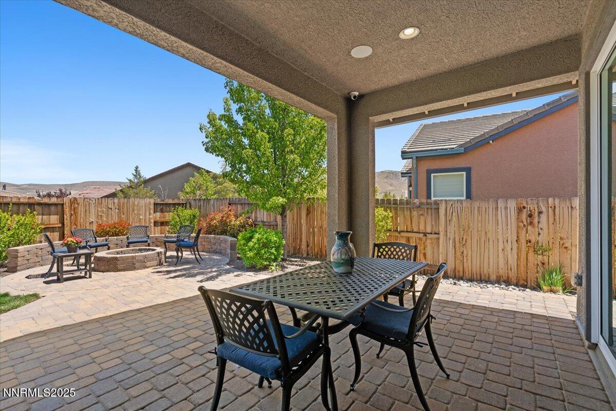 9822 Dyevera Lane Reno, NV 89521 - Photo 34 of 44 a view of a patio with table and chairs and potted plants
