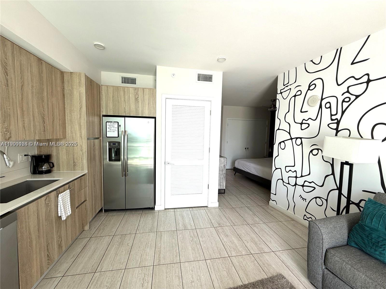 3900 Biscayne Boulevard, Unit N723 Miami, FL 33137 - Photo 12 of 30 a kitchen with stainless steel appliances granite countertop a refrigerator and a sink