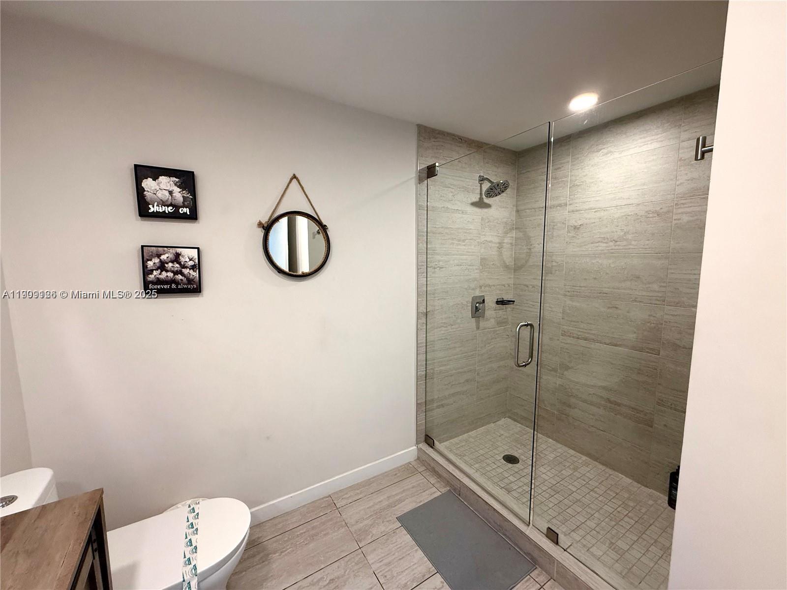 3900 Biscayne Boulevard, Unit N723 Miami, FL 33137 - Photo 15 of 30 a bathroom with a shower a toilet and sink