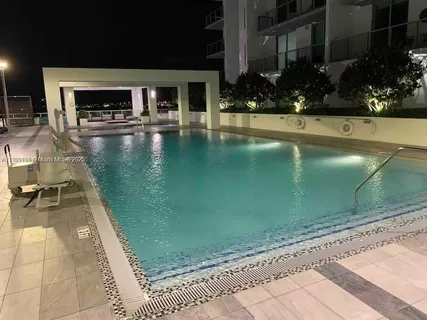 a view of a swimming pool with potted plants