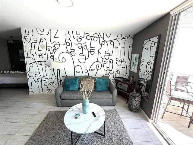 a view of a kitchen with a refrigerator and a stove top oven