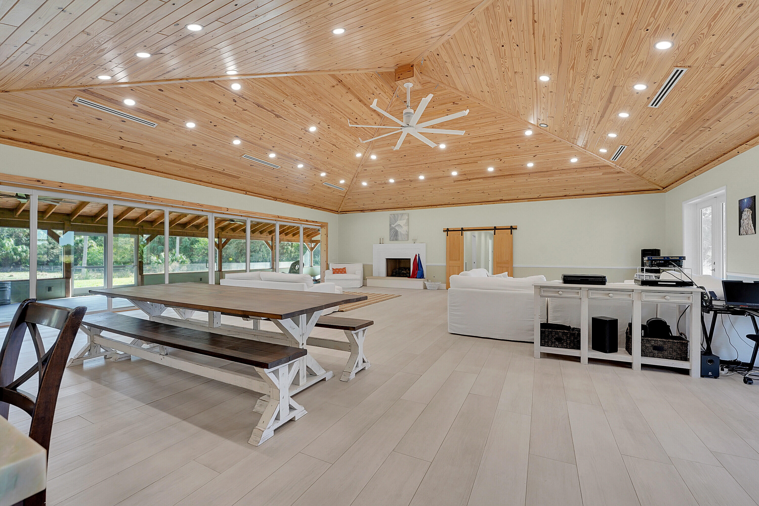 a living room with furniture a large window and white table