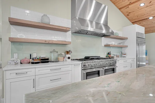 a bed sitting in a spacious bedroom next to a window