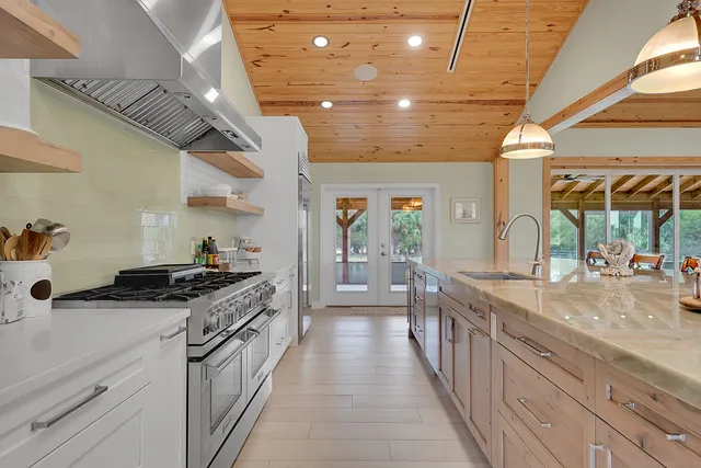 a bathroom with a granite countertop sink mirror and toilet