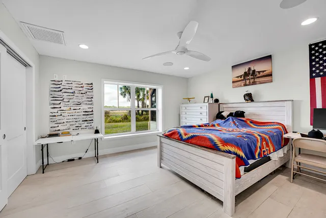 a bedroom with a large bed and a window
