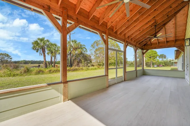 a view of a room with wooden floor and windows
