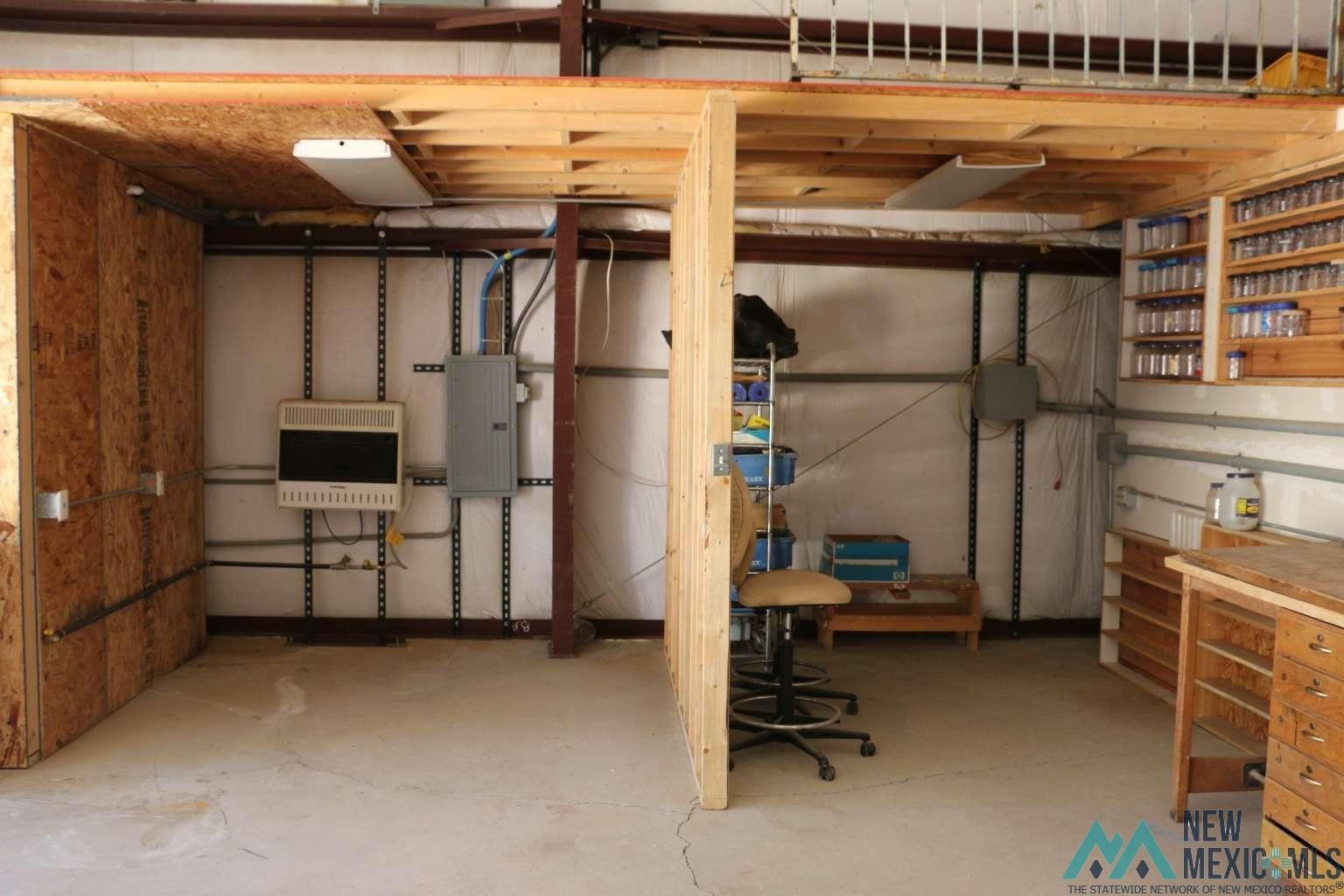 32 Dan Gatlin Road Pie Town, NM 87827 - Photo 20 of 43 Unfinished below grade area featuring heating unit and electric panel