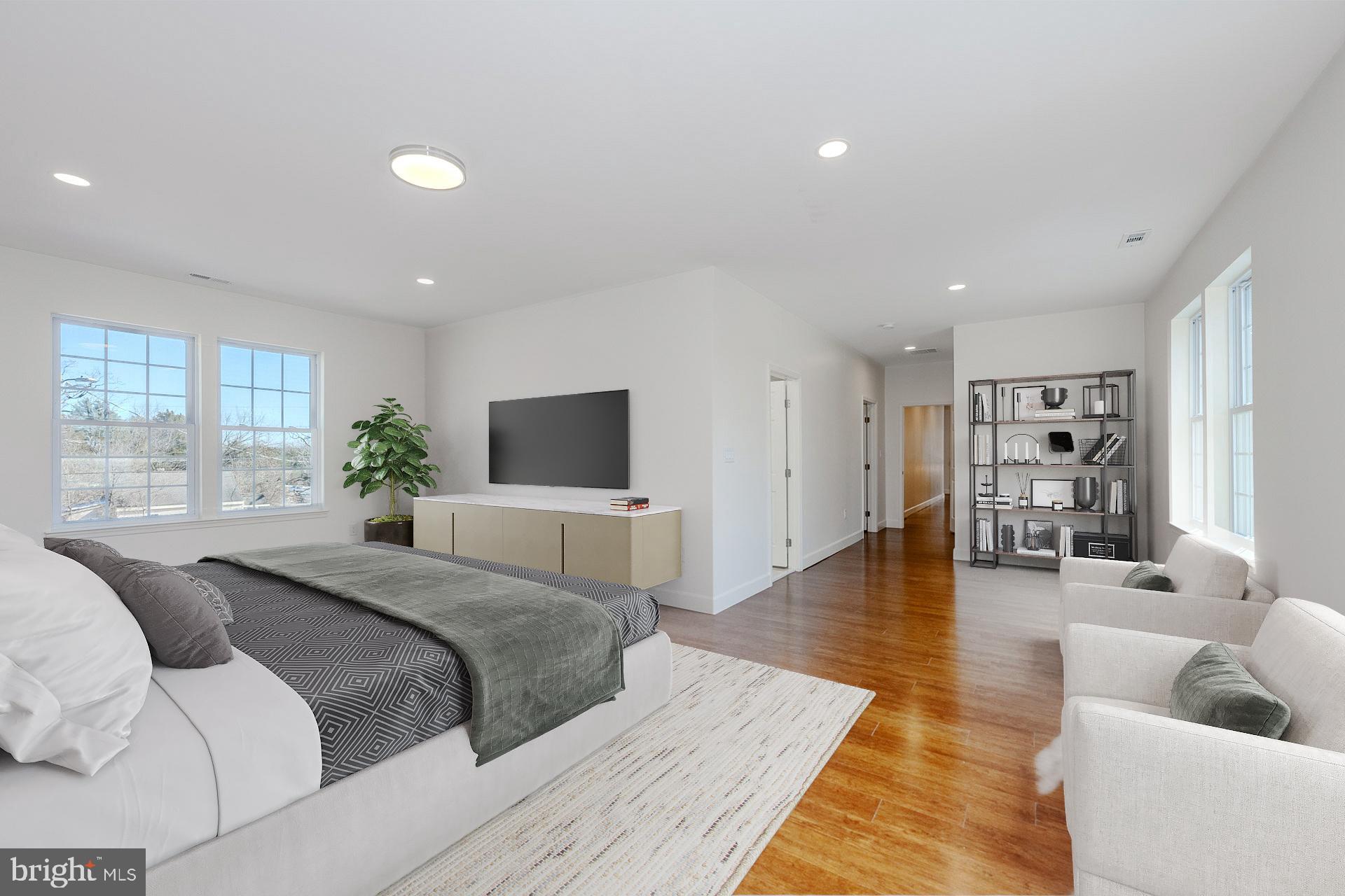 12300 Braddock Road Fairfax, VA 22030 - Photo 12 of 70 a spacious bedroom with a large bed a couch and a window