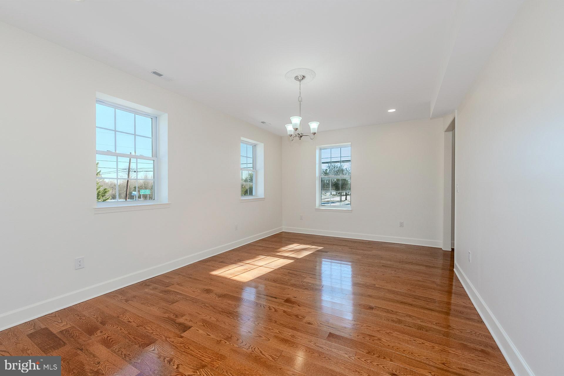 12300 Braddock Road Fairfax, VA 22030 - Photo 22 of 70 an empty room with wooden floor and windows