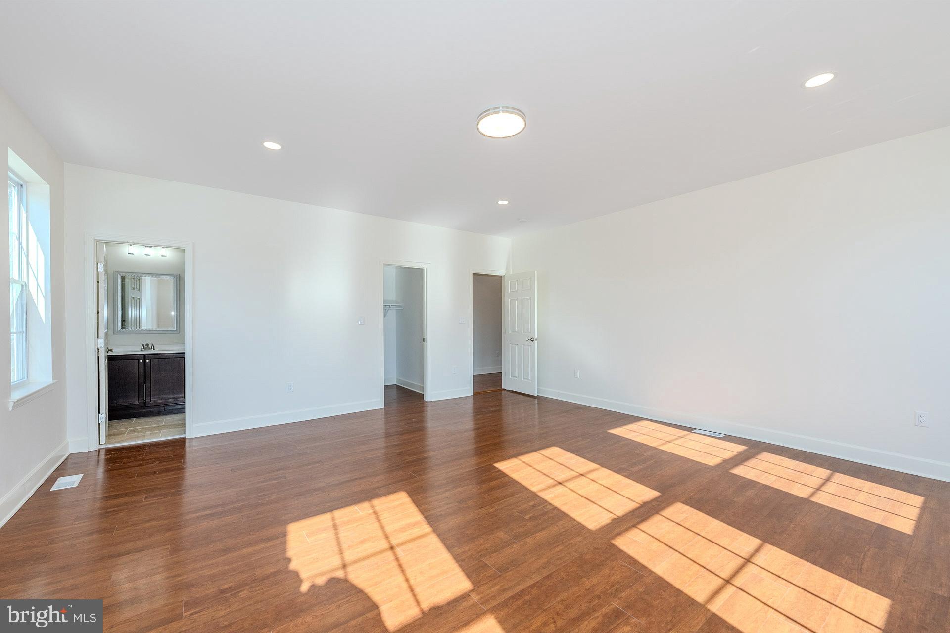 12300 Braddock Road Fairfax, VA 22030 - Photo 25 of 70 a view of an empty room with wooden floor and a window