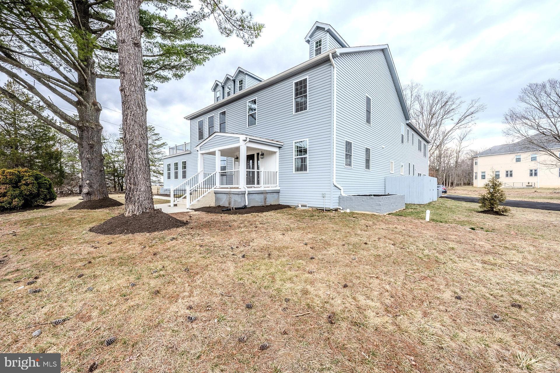 12300 Braddock Road Fairfax, VA 22030 - Photo 4 of 70 a view of a white house with a yard covered in snow