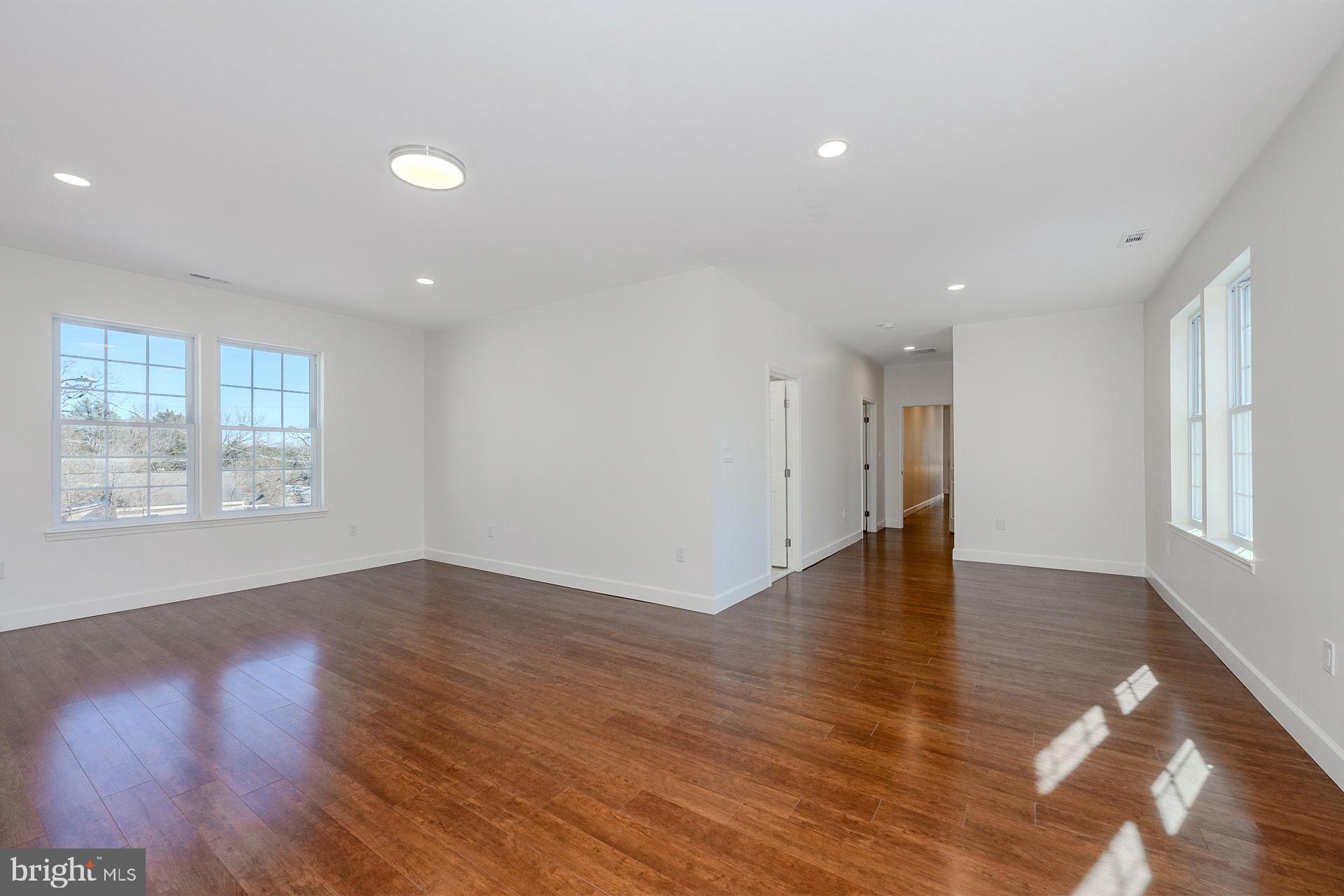 12300 Braddock Road Fairfax, VA 22030 - Photo 41 of 70 an empty room with wooden floor and windows