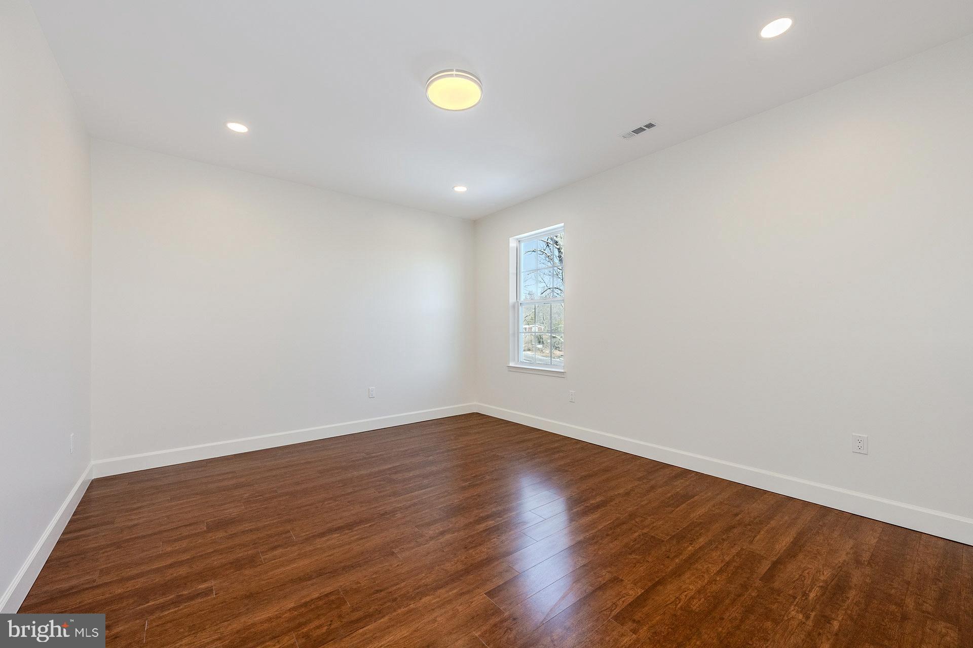 12300 Braddock Road Fairfax, VA 22030 - Photo 47 of 70 a view of an empty room with wooden floor and a window